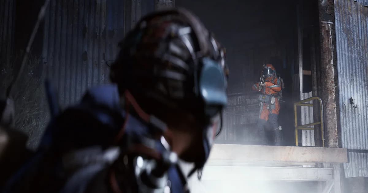 Two orange-suited Raiders confront each other inside a dim industrial warehouse, one blurred in the foreground