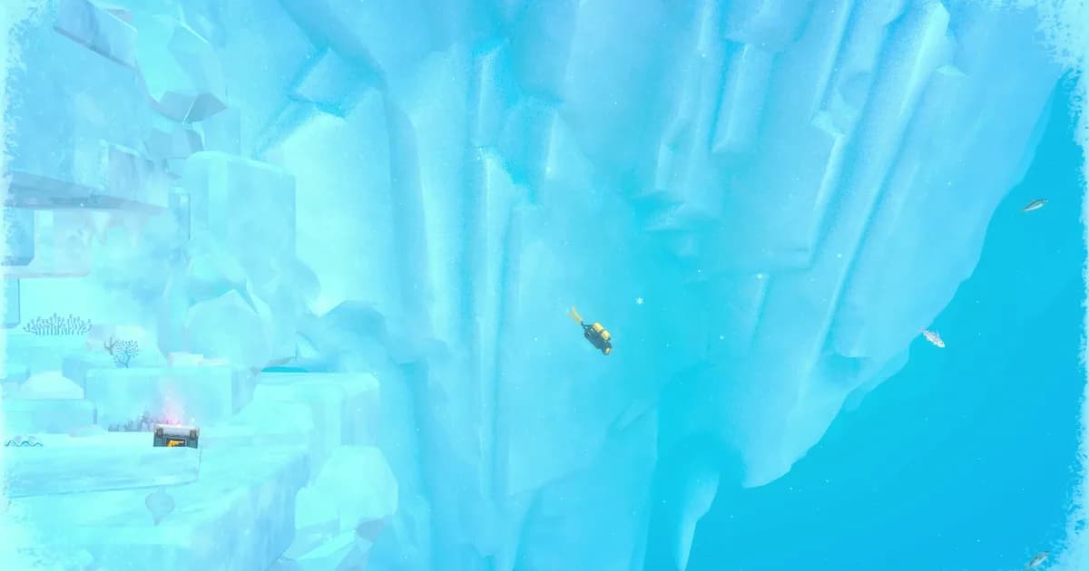 Dave in his yellow dive gear descending past a towering wall of pale blue ice in the frozen Glacial Area of the Blue Hole